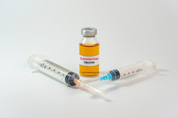 Coronavirus vaccine in bottle and syringe for COVID-19 pandemic concept