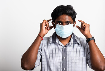 Asian happy portrait young black man wearing face mask protective from virus coronavirus epidemic or air pollution looking camera, studio shot isolated on white background, stop COVID-19 concept