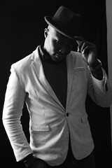 African man in suit hats off