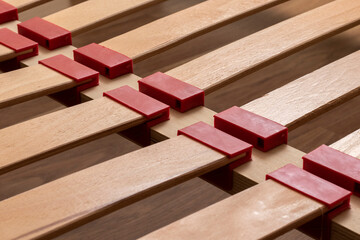Curved wooden slats beds close up.