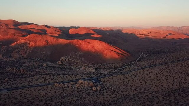Aerial Shot Of Desert Landscape And Mountains In Joshua Tree National Park At Sunset
