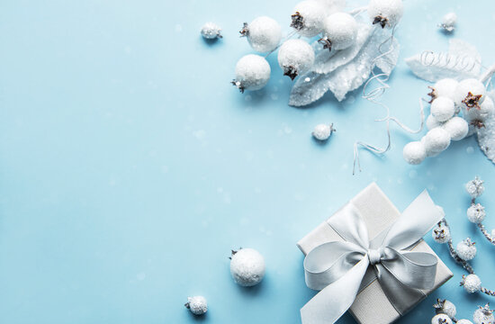 Frame made of white decorations on pastel blue background