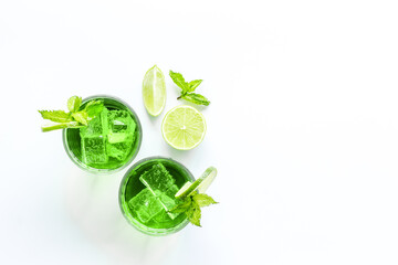 Green iced cocktail drink witn lime and mint, top view
