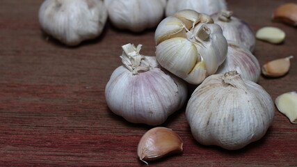 Garlic on wooden background, copy space.