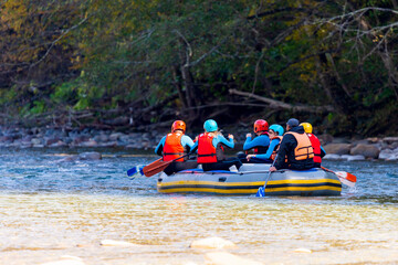 Group of young people make a rafting on mountain river