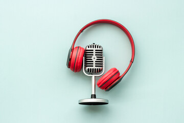 Podcast and streaming record. Microphone and headphones on table, top view