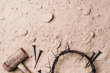 Good Friday, Passion of Jesus Christ. Crown of thorns, hammer, old nails on ground. Christian Easter holiday. Top view, copy space. Crucifixion, resurrection of Jesus Christ. Gospel, salvation