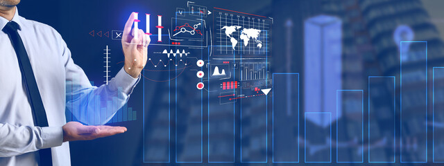 Business consultant using virtual screen on dark background