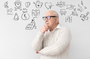 Elderly man planing his budget on light background
