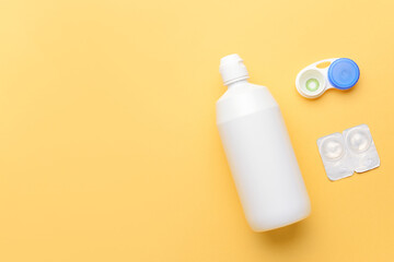 Container with contact lenses and  solution on color background