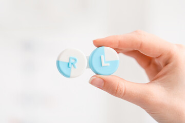 Woman holding contact lens case