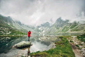Traveler at Lake Hincovo Pleso in High Tatras.