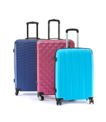 Packed suitcases on white background