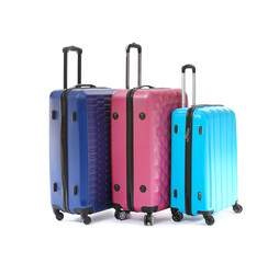 Packed suitcases on white background