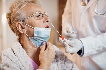 Close-up of senior woman having PCR test at nursing home.