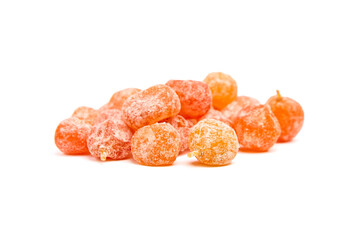 Candied fruits, heap of dried kumquats isolated on white background