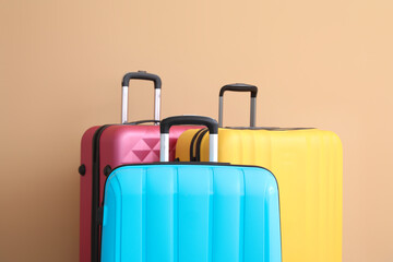 Packed suitcases near color wall