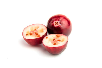 Halves and whole fresh red fall cranberries isolated on white