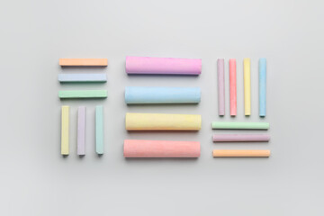 Composition with colorful chalks on color background