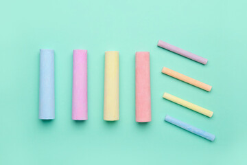 Composition with colorful chalks on color background