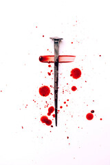 Christian cross made with rusty nails, drops of blood on white background. Copy space. Good Friday,...