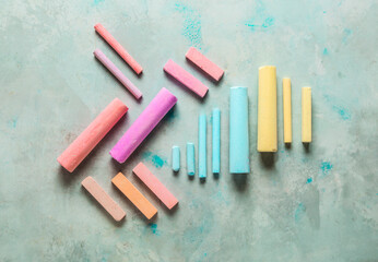 Composition with colorful chalks on grunge background