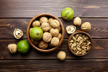 Walnuts in round bowl on wooden table