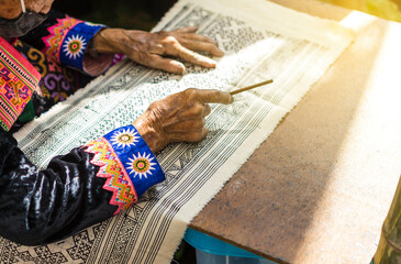 Hmong women drawing pattern with wax, Hill tibe textile design in North of Thailand