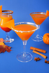 Glasses of tasty pumpkin pie martini on color background