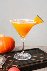 Glass of tasty pumpkin pie martini on table