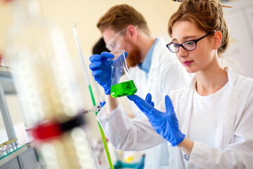 Group of medical research scientists collectively working in laboratory