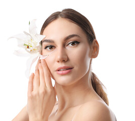 Fototapeta premium Young woman with white lily flower natural beauty and skincare concept freshness and purity isolated on white background
