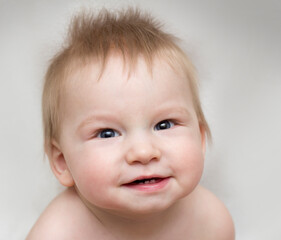 Portrait of a cute smiling baby that showing first milk or temporary teeth