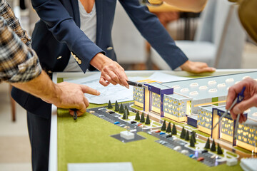 team of architectural engineers artists creating design with scale model home,coworking, have successful cooperation, discussing