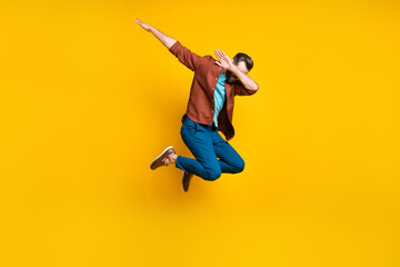Full length body size photo of male student showing hype dab sign jumping isolated on vivid yellow color background