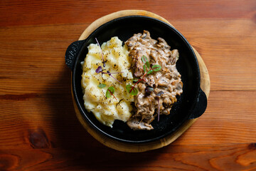 Meat with mushrooms and mashed potatoes.
