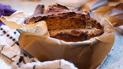 Freshly baked homemade sourdough rye bread with a thick crust and a deep cut