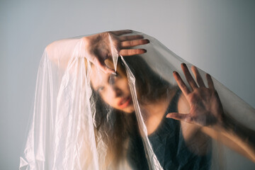 Woman protection. Defocused art portrait. Self isolation. Social pressure. Trapped anxious...