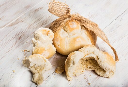 michetta bread over white wooden table