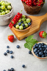 Composition with summer berries blueberries, gooseberries, red currant