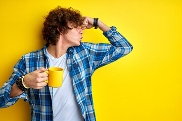 strong male feel power drinking coffee, holding cup in hands, smiling, show muscles in hands, kissing muscles
