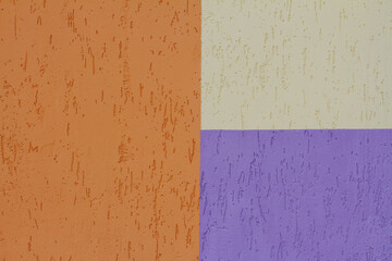 Colorful (orange, yellow and purple) painted decorative wall as background, texture
