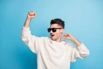 Fototapeta premium Photo portrait of cool guy with stubble dancing isolated on pastel blue colored background