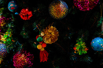 Fototapeta na wymiar Colorful Christmas balls on the branches fir , Decorated Christmas tree. New Year Decoration festive background with vintage tone and selective focus. High quality photo