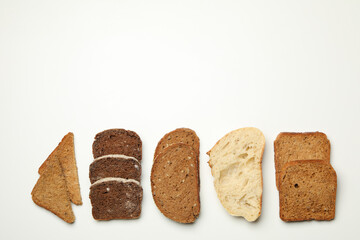 Different bread slices on white background, space for text