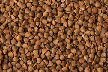 Close up above view photo of raw brown buckwheat detailed texture