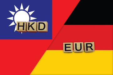 Taiwan and Germany currencies codes on national flags background