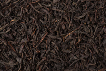 Close up top above view macro photo of dry black tea texture background