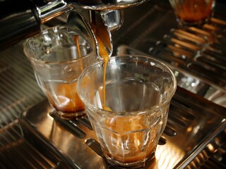Close up making espresso in glass cup with traditional coffee machine.