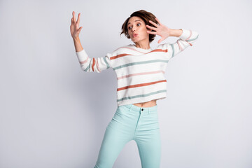 Photo of pretty shiny young woman dressed striped pullover dancing rising arms isolated grey color background